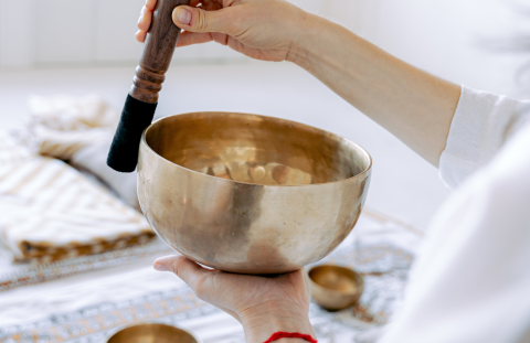 Photo of someone using a singing bowl for meditation
